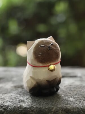 Wooden Siamese cat figurine.